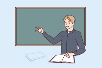 Priest teaching sunday school visitors stands near blackboard and tells students about benefits of