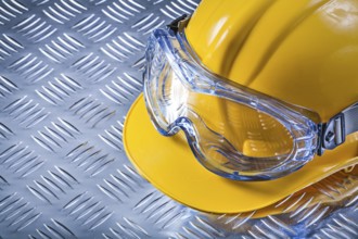 Protective glasses building helmet on grooved metal sheet construction concept