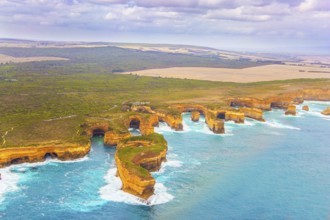 Aerial view. Helicopter flight over the scenic Pacific coastline. Australia. The Twelve Apostles