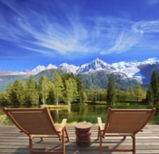 City park in the Alpine resort. Comfortable lounge chairs on wooden platform for rest and