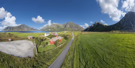Aerial view of Flakstad church. In the background the peaks of the mountains Hustinden,