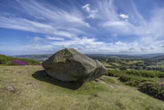 Large rock on a hill with sweeping views over a green landscape around Conwy and Conwy Castle on