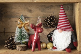 Christmas decoration deer figure and gnome in a wooden box background