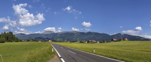 Panoramic landscape of fields and Alps mountains in central Styria, Austria