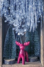 An image of some Christmas decoration in an old wooden box
