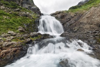 Scenery summer mountain landscape of Kamchatka Peninsula: beautiful view of cascade of flowing
