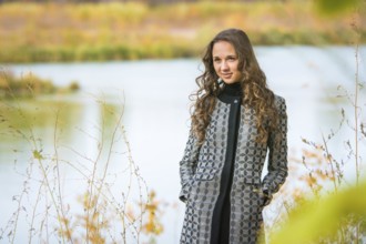 Twenty-five young beautiful girl walks by Europeans autumn forest
