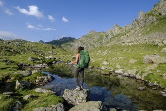 Hiker on Lac Bersau, Ayous lakes tour, Pyrenees National Park, Pyrenees Atlantiques, France
