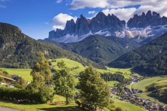 Dolomites, Val de Funes valley. Lovely autumn day. Picturesque mountains surround the green alpine