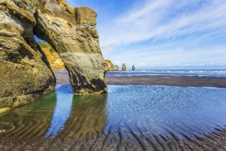 Coastal rock arches Three Sisters and Elephant on the Pacific coast. The concept of active and