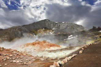 Rhyolite mountains smoldering underground heat. In the hollows lie unmelted snow patches from last