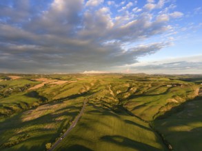Tuscany aerial sunrise farmland hill country landscape. Italy