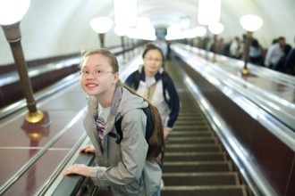 A girl (11 years) lifts on a metro escalator