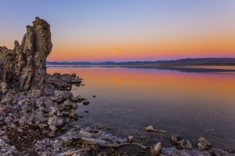 Magic sunset on the lake. Lime-tuff towers of bizarre shapes rise from the bottom of the lake. The