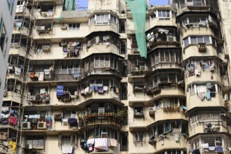 High-rise building with numerous rounded balconies and hanging laundry, Aurangabad, Mumbai, South