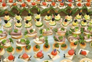 A lot of canapes with skewers and sandwiches on buffet table, shallow DOF