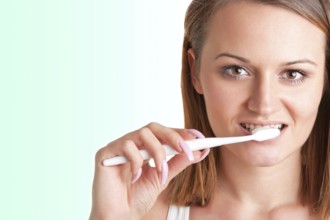 Closeup of young woman with a tooth brush on her hands, about to brush her teeth