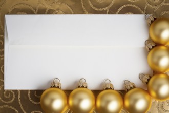 Blank paper card framed Christmas balls on gold