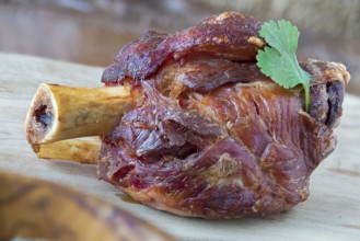 Grilled pork knuckle on a wooden board