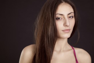 Beauty young girl face on dark background