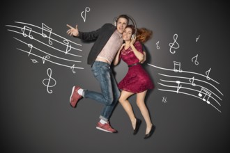 Happy valentines love story concept of a romantic couple sharing headphones and listening to music