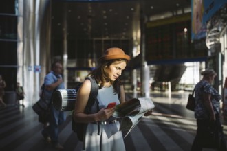 Theme travel and transportation. Beautiful young caucasian woman in dress and backpack standing