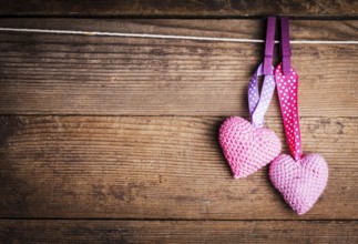 Crochet valentine hearts handing on the rope. Valentine's day greeting card. Love concept