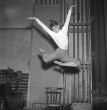 In the 1950s. An unknown young woman is pictured in the moment when being highest in the air having