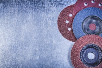 Grinding discs abrasive flap wheels on scratched metallic background copy space