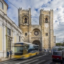 Bus in movement, Historic cathedral with a bus passing by under a cloudy sky in an urban setting,