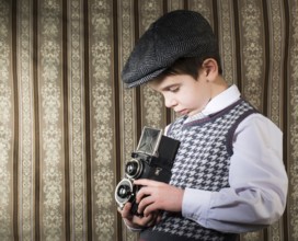 Boy with vintage camera. Vintage clothes