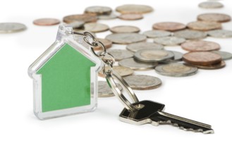 Coins and green house key ring. White isolated studio shot