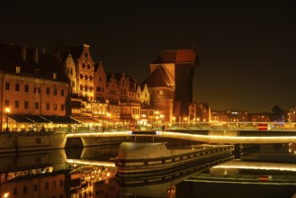 Old town in Gdansk at night. The riverside on Granary Island reflection in Moltawa River Cityscape