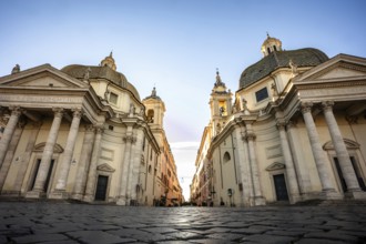 Two churches flank a street at dawn Piazza del Popolo, Rome