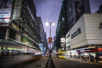 HONG KONG, CHINA - SEPTEMBER 28, 2024: Busy Nathan Rd at night with famous signage, architecture
