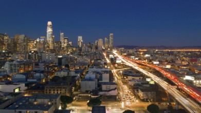 Cars go into and out of San Francisco Downtown night time rush hour