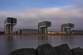View over the Rhine with crane houses, sunrise, long exposure, Cologne, Germany