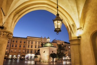 City of Krakow by night in Poland, Ranaissance arch of the Cloth Hall (Sukiennice), St. Adalbert