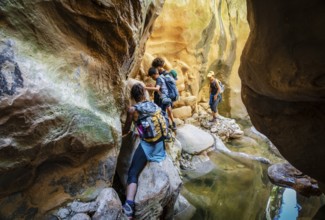 Walkers dodging waterlogged stretches, Torrent de Pareis, Sa Calobra, Majorca, Balearic Islands,