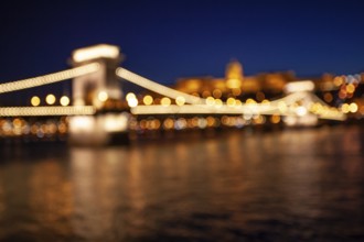 Blurred chain bridge in Budapest at night. Hungarian landmarks. Danube river