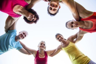 Close-up of fit girls putting hands on top of each other as symbol of successful collaboration