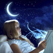 Girl sitting in bed and using her tablet pc
