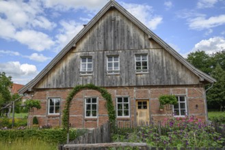 Traditional half-timbered farmhouse under a clear blue sky, burlo, münsterland, germany
