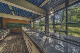 Sunlit, abandoned laboratory with old lab benches and a view of the countryside, Institute of