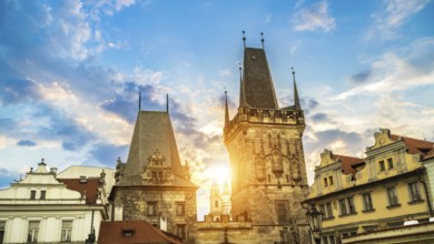 Malostranska Tower on Charles Bridge and morning sun in Prague