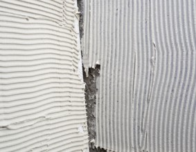 Construction notched trowel mortar shape on big tile back side