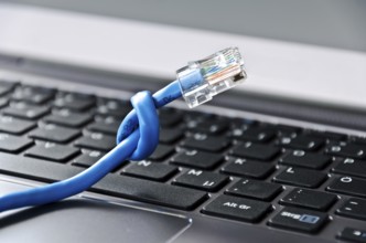 Internet cable with knot on a computer keyboard