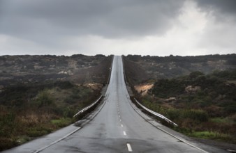 Empty asphalt highway road and stormy sky. Concept of achieving goals