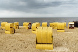 Sandy beach and typical hooded beach chairs in Cuxhaven in the North Sea coast a cloudy day of