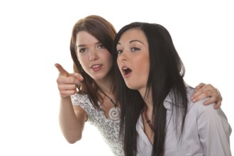 Two young girls see something very funny and laugh